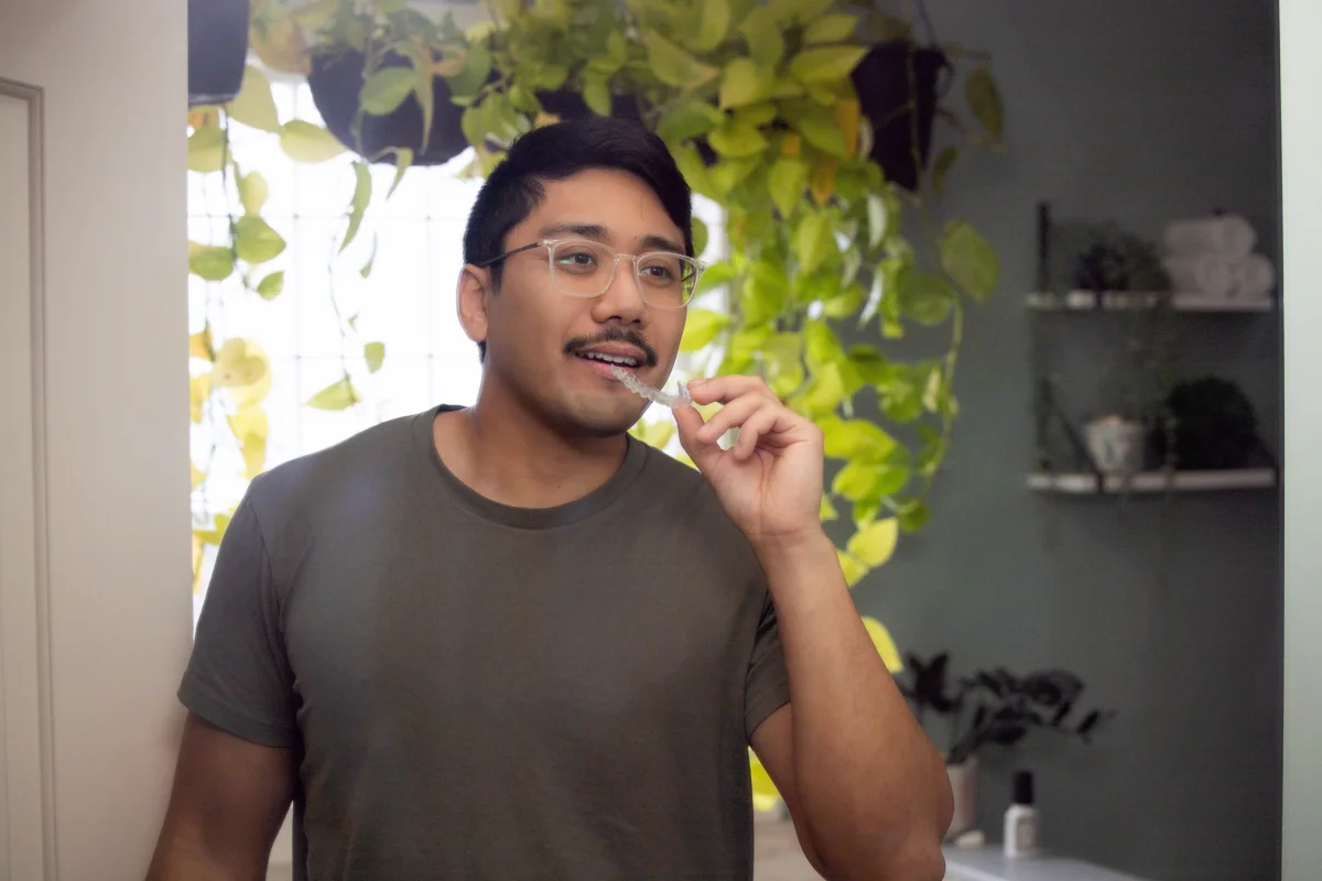 Retainers After Braces: How to Keep Your Smile Straight Clear removable retainer held after finishing orthodontic treatment in Brisbane
